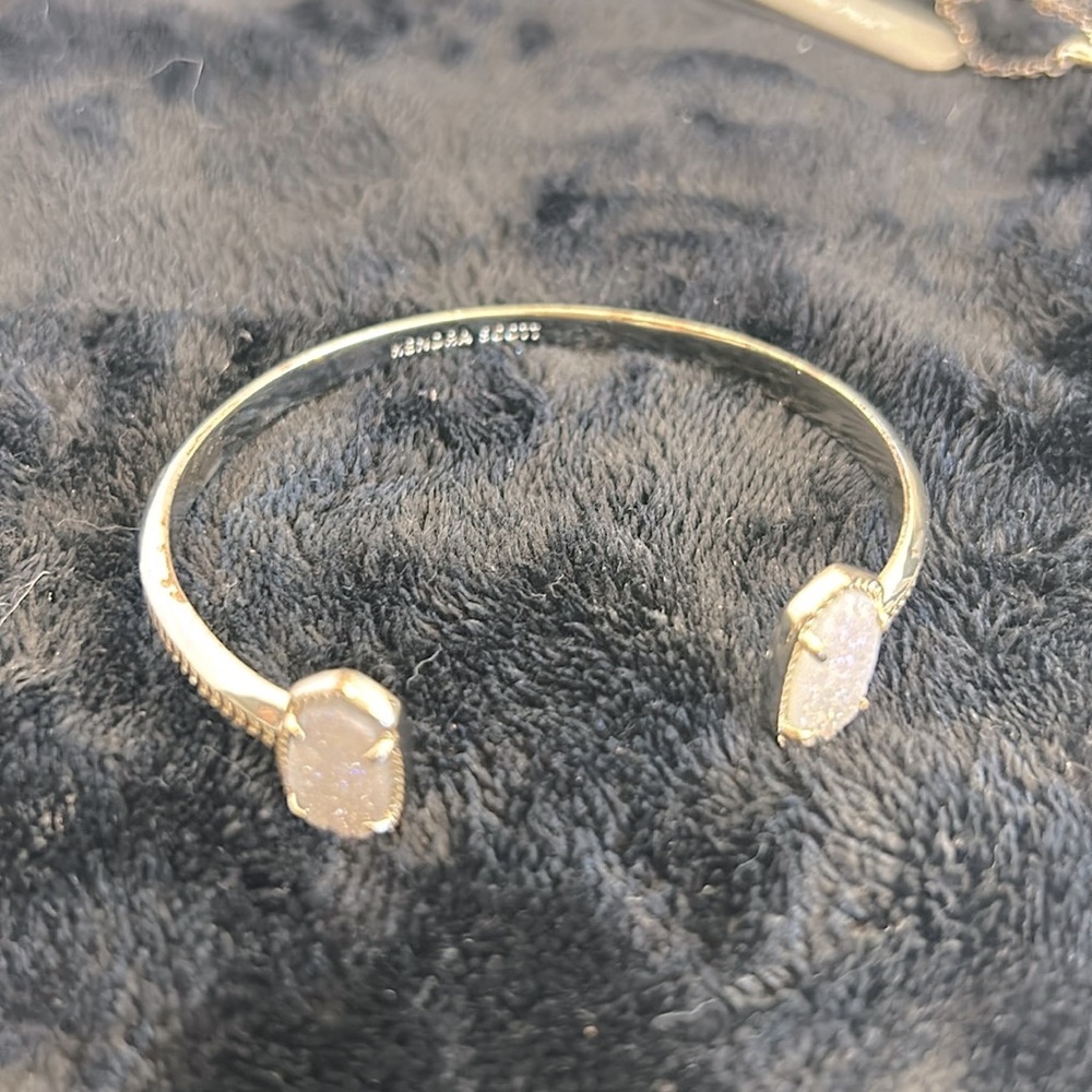 Kendra Scott gold cuff bracelet with sparkling opaque stones